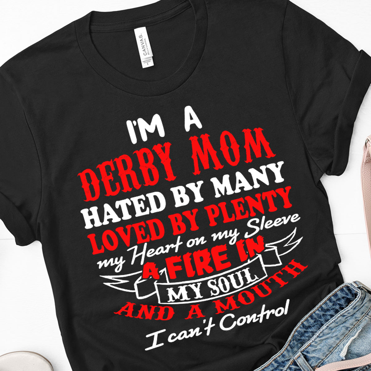 Premium women's black graphic t-shirt mockup featuring a bold, high-contrast white typographic design that reads "I'm a Derby Mom, Hated by Many, Loved by Plenty, Heart on my Sleeve, Engine on the Limit".