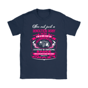 Premium women's black graphic t-shirt mockup featuring a vibrant pink and white custom design that reads "I'm not just a Demolition Derby Mom, I'm a big cup of wonderful covered in awesome sauce with a splash of sassy and a dash of crazy" with a derby car illustration.