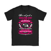 Premium women's black graphic t-shirt mockup featuring a vibrant pink and white custom design that reads "I'm not just a Demolition Derby Mom, I'm a big cup of wonderful covered in awesome sauce with a splash of sassy and a dash of crazy" with a derby car illustration.