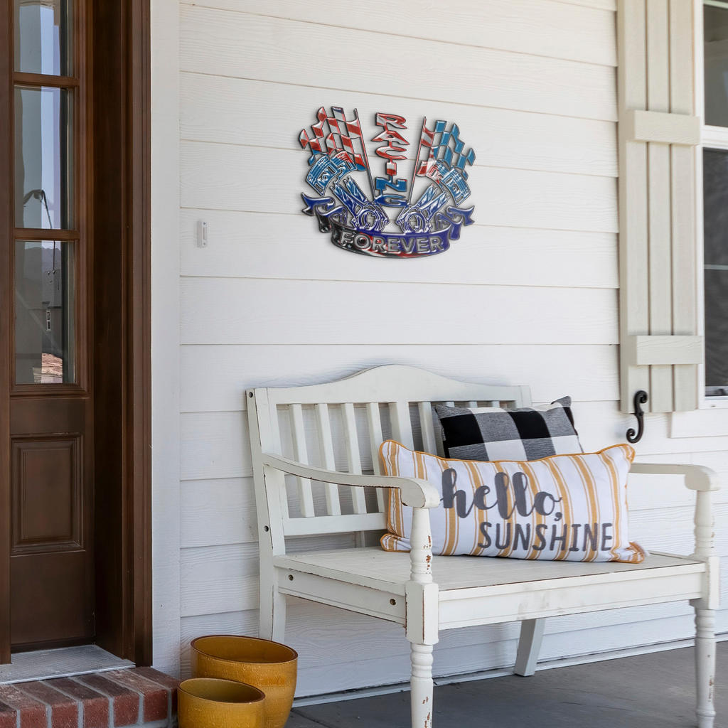 Racing Forever metal sign on white porch siding above a white bench with decorative pillows.