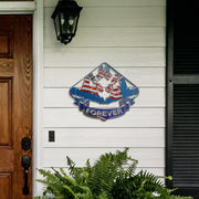 Red, white and blue Go-Kart Forever sign on white porch siding beside a wooden door and fern.