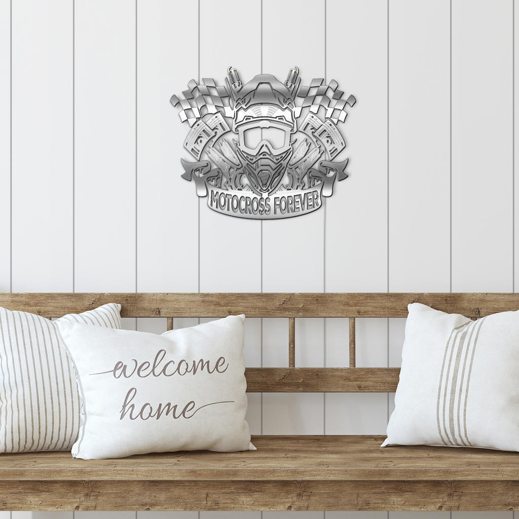 Silver-look motocross metal sign above a wooden bench with white cushions.