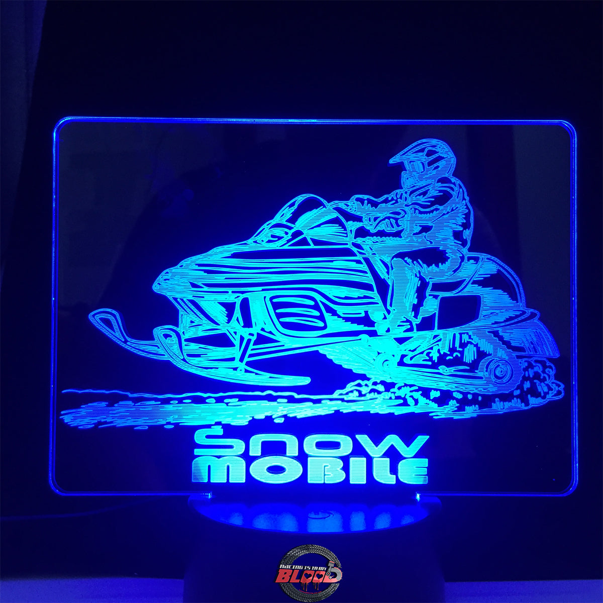 Snowmobile 3D LED Lamp featuring a detailed high-performance sled silhouette glowing in a vibrant ice blue on a premium black base.