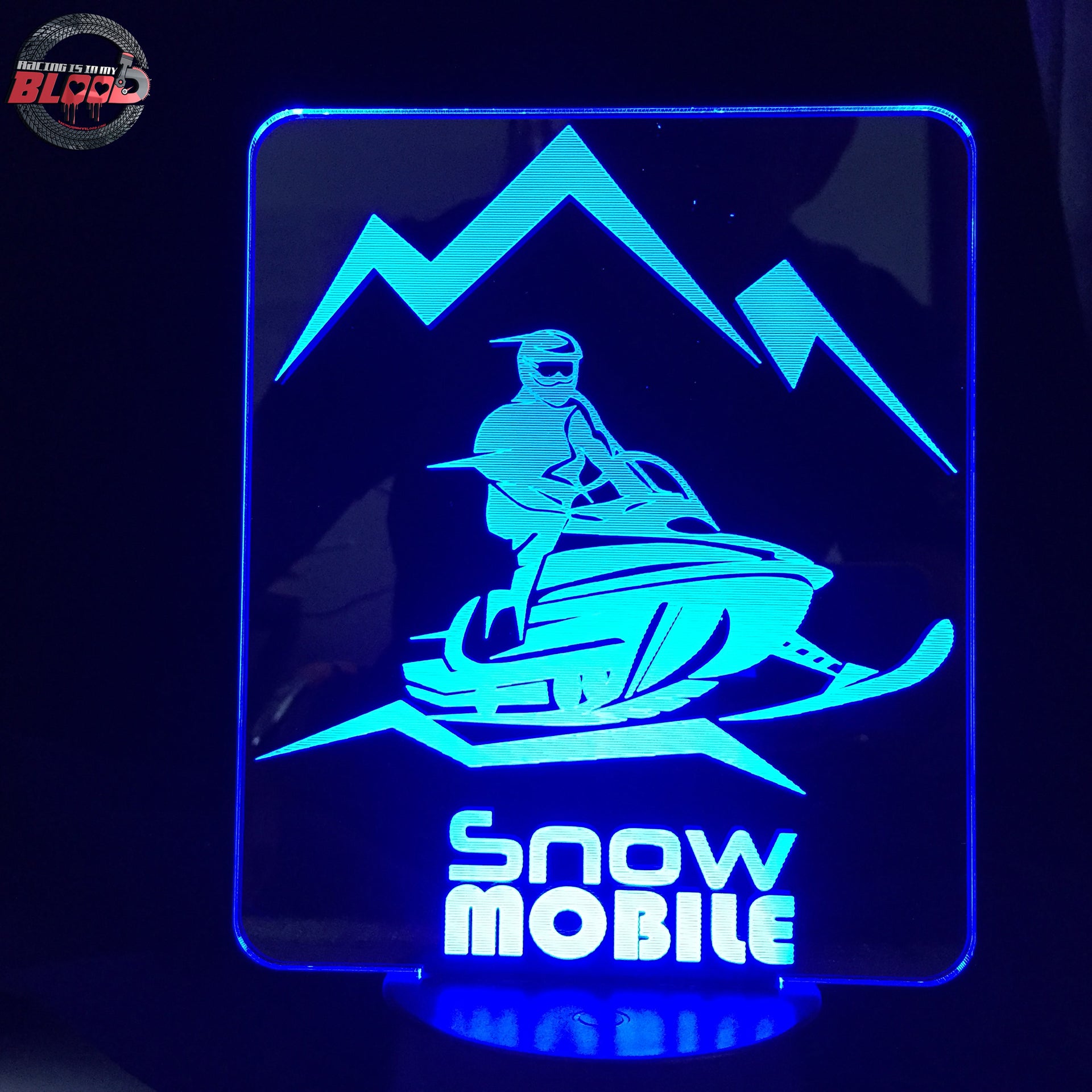 Snowmobile 3D LED Lamp featuring a detailed modern sled silhouette glowing in a vibrant icy white on a premium black base.