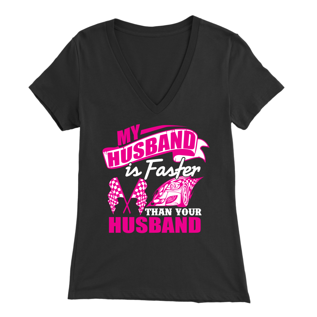 Woman sitting in the grandstands at a race track wearing a dark gray v-neck t-shirt with a pink and white graphic that reads "My Husband Is Faster Than Your Husband" alongside a race car and checkered flags.