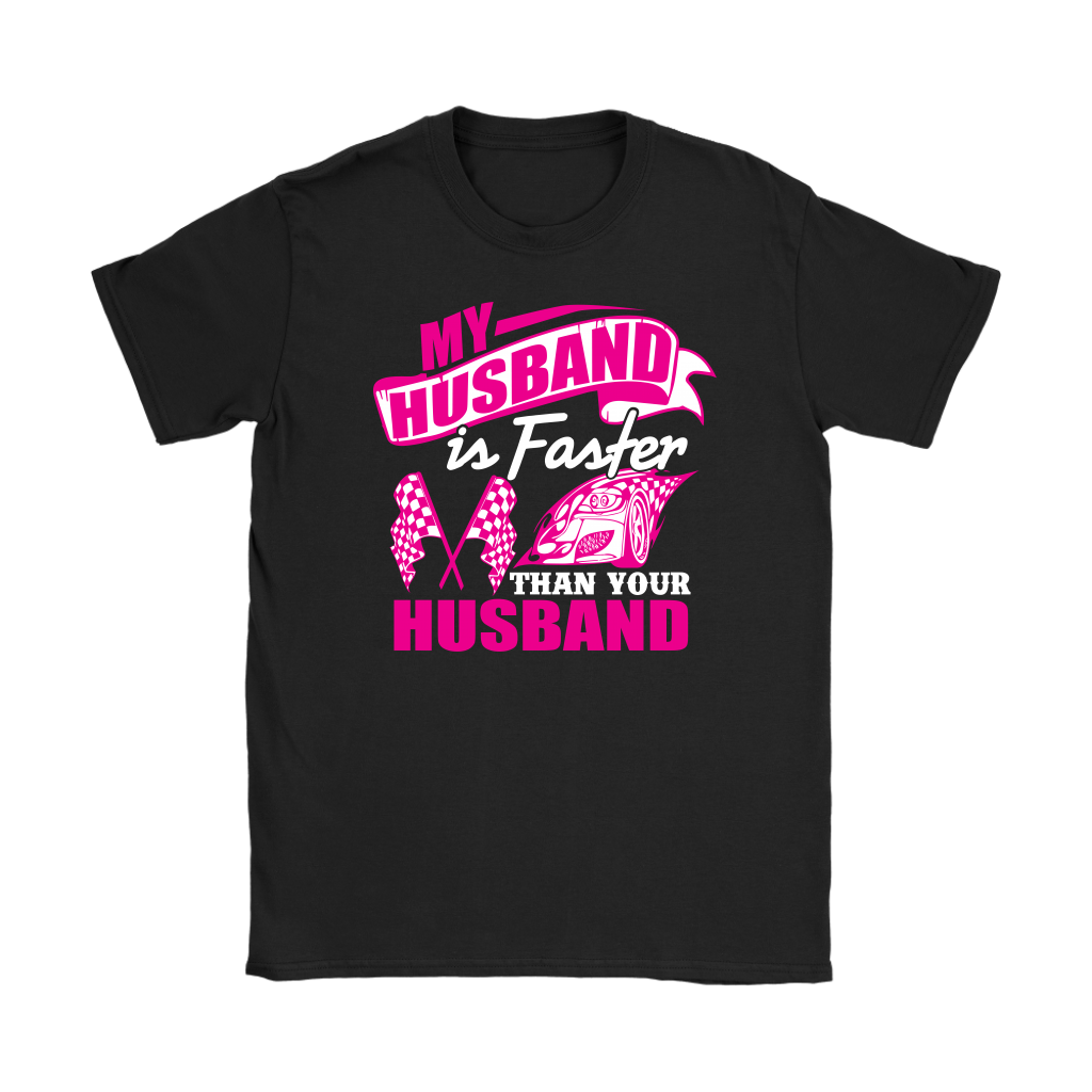 Woman sitting in the grandstands at a race track wearing a dark gray v-neck t-shirt with a pink and white graphic that reads "My Husband Is Faster Than Your Husband" alongside a race car and checkered flags.
