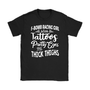 Women's F-Bomb Racing graphic apparel featuring the bold "Girl With Tattoos, Pretty Eyes, And Thick Thighs" slogan available in t-shirts, racerback tanks, and hoodies.