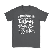 Women's F-Bomb Racing graphic apparel featuring the bold "Girl With Tattoos, Pretty Eyes, And Thick Thighs" slogan available in t-shirts, racerback tanks, and hoodies.