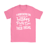 Women's F-Bomb Racing graphic apparel featuring the bold "Girl With Tattoos, Pretty Eyes, And Thick Thighs" slogan available in t-shirts, racerback tanks, and hoodies.