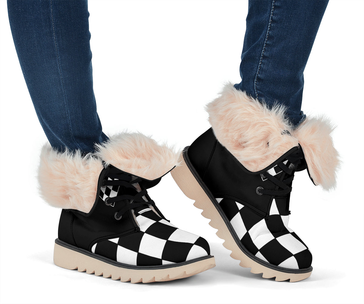 Women's black-and-white checkered boots worn with jeans, with cream-lined cuffs folded down.