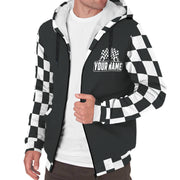 A race fan wearing a custom-printed sherpa-lined racing jacket while standing in the grandstands of an illuminated dirt track at night, with the race cars visible in the background.