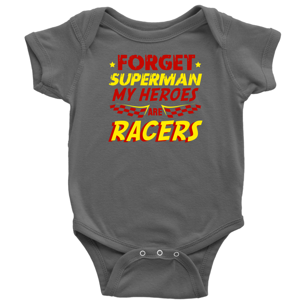 A young, excited child wearing a "Forget Superman My Superheroes Are Racers" t-shirt standing in the pit area, happily high-fiving a local race car driver dressed in a professional fire suit.