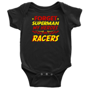 A young, excited child wearing a "Forget Superman My Superheroes Are Racers" t-shirt standing in the pit area, happily high-fiving a local race car driver dressed in a professional fire suit.