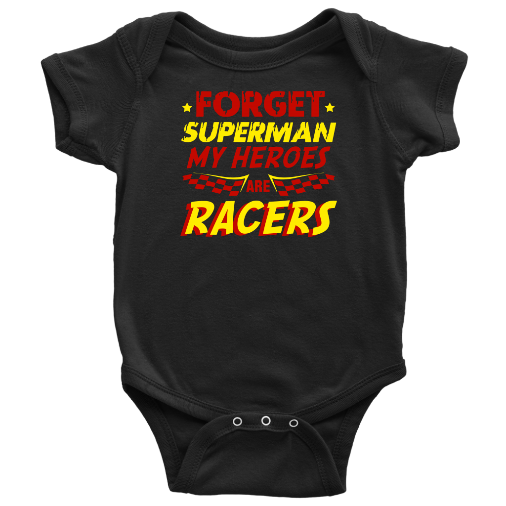 A young, excited child wearing a "Forget Superman My Superheroes Are Racers" t-shirt standing in the pit area, happily high-fiving a local race car driver dressed in a professional fire suit.