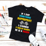 A collection of a youth t-shirt, baby bodysuit, and hoodie displaying the funny quote "If I Say Something Inappropriate I Learned It From My Grandpa He Is A Racer" in bold, playful typography with racing flag accents, set against a clean white background.