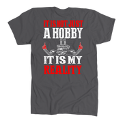 Custom drag racing apparel featuring the quote It Is Not Just A Hobby It Is My Reality for hot rod and quarter-mile speedway fans.