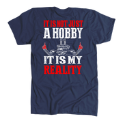 Custom drag racing apparel featuring the quote It Is Not Just A Hobby It Is My Reality for hot rod and quarter-mile speedway fans.