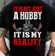 Custom drag racing apparel featuring the quote It Is Not Just A Hobby It Is My Reality for hot rod and quarter-mile speedway fans.