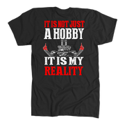 Custom drag racing apparel featuring the quote It Is Not Just A Hobby It Is My Reality for hot rod and quarter-mile speedway fans.